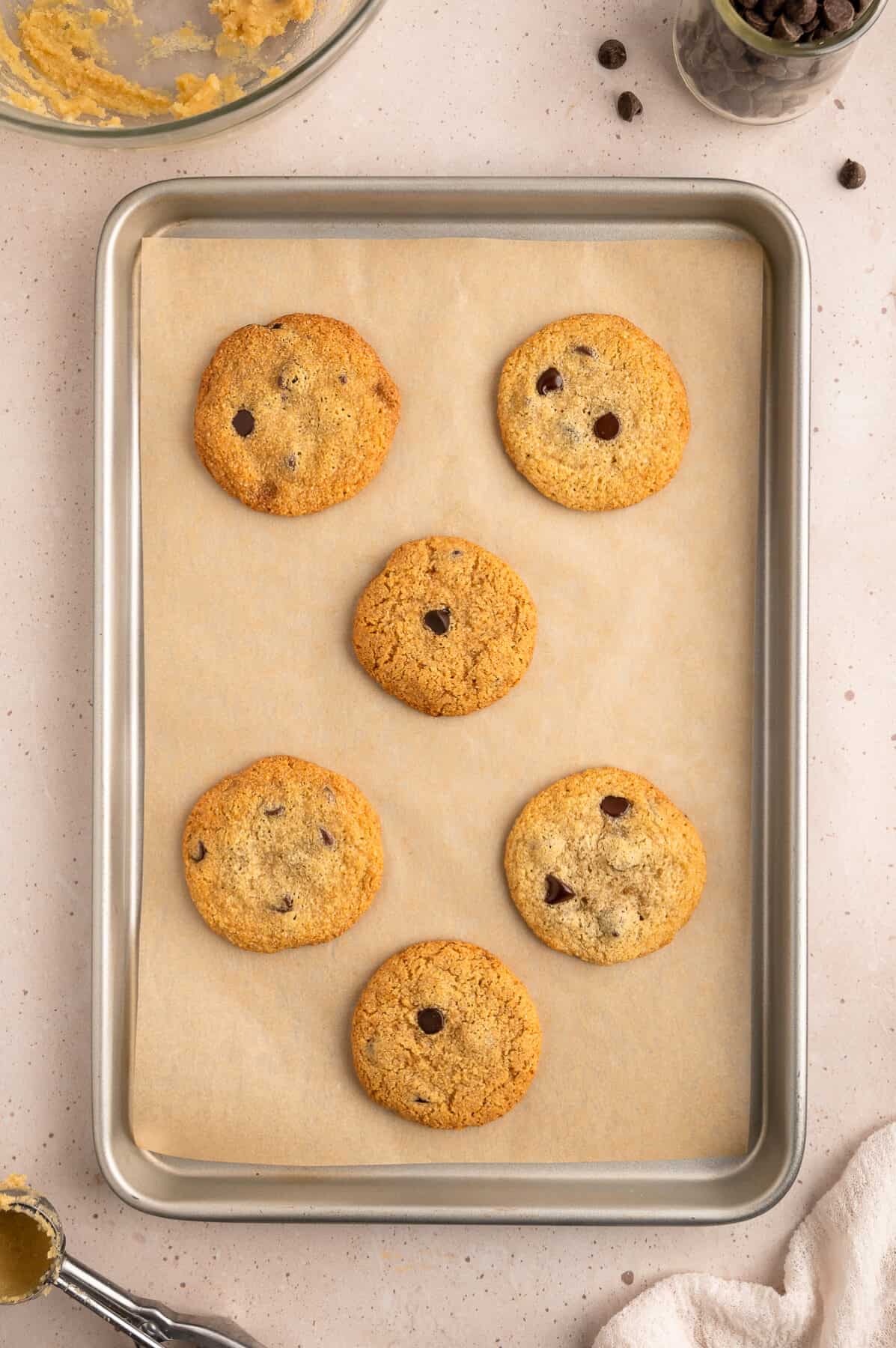 baked almond flour chocolate chip cookies on a baking sheet. 