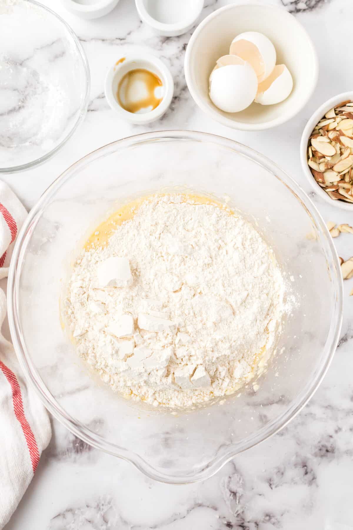 flour on top of the creamed sugar butter mixture in a large glass mixing bowl.