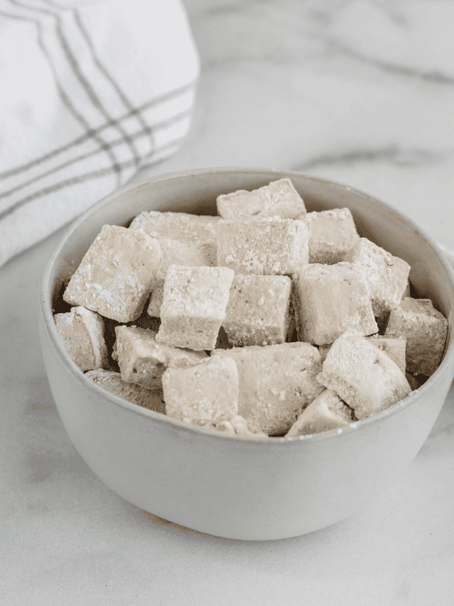 white bowl filled with healthy marshmallows and a white tea towel to the side.