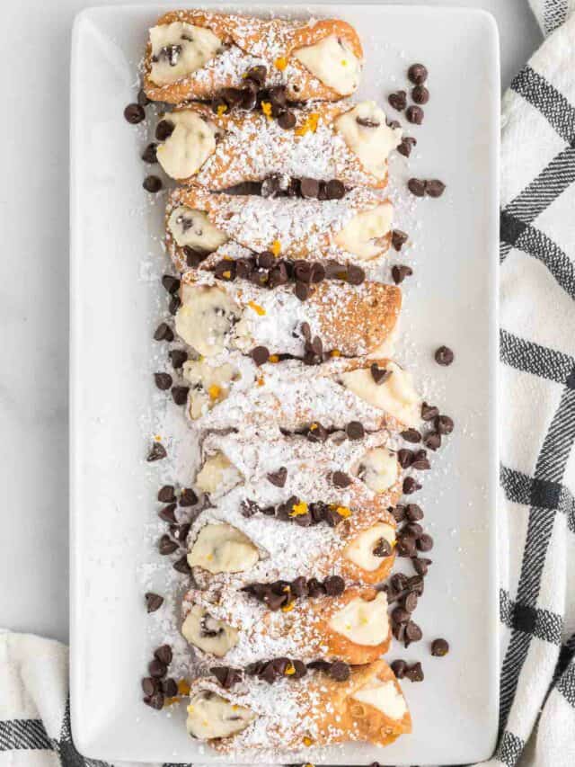 white tray platter filled with cannolis.