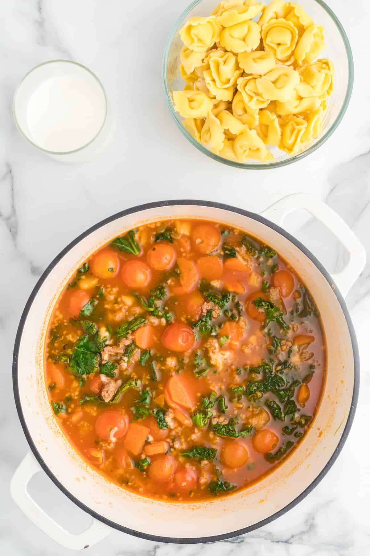 kale added to the soup pot with the meat and vegetables and broth.