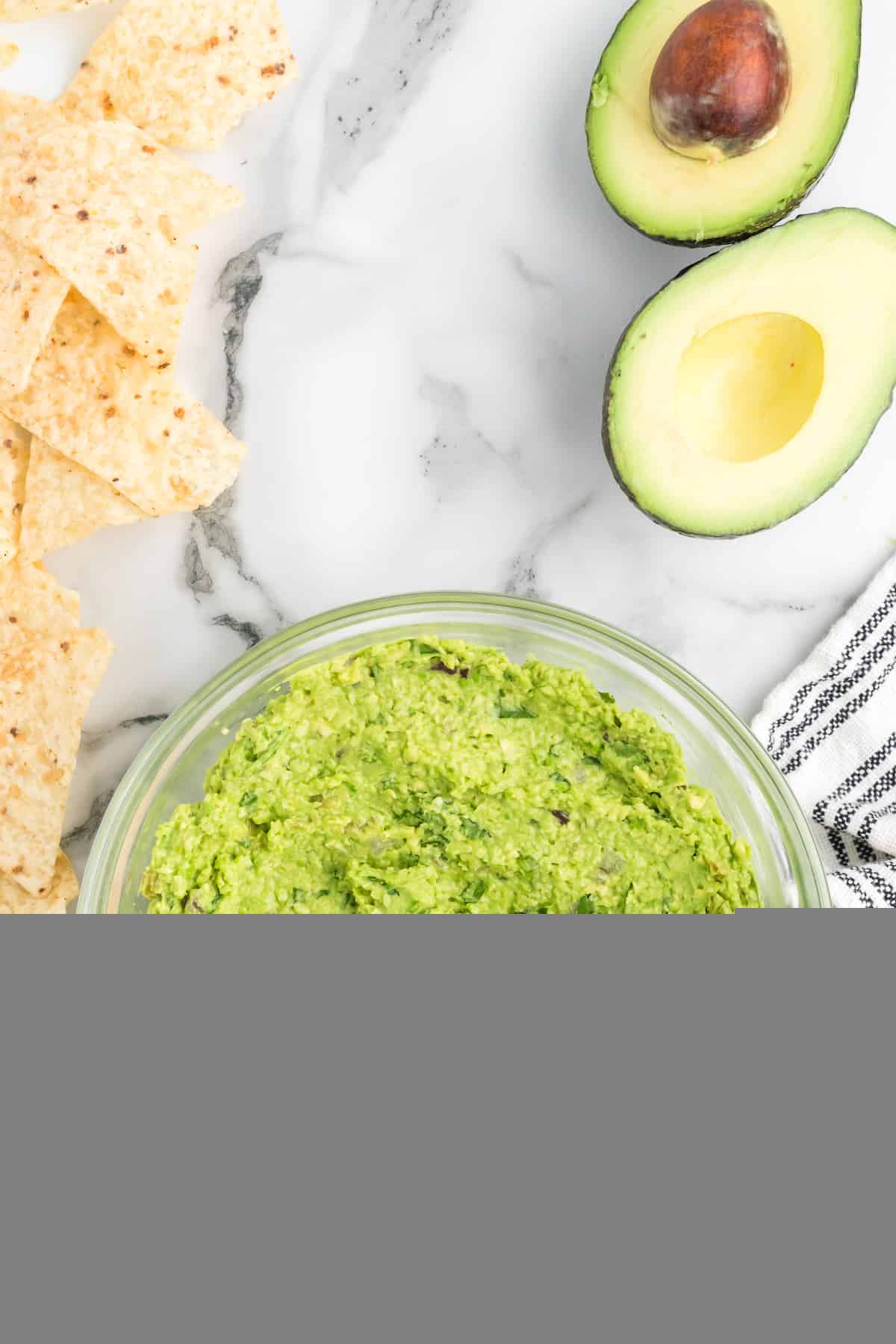 fresh guacamole in a large glass bowl.