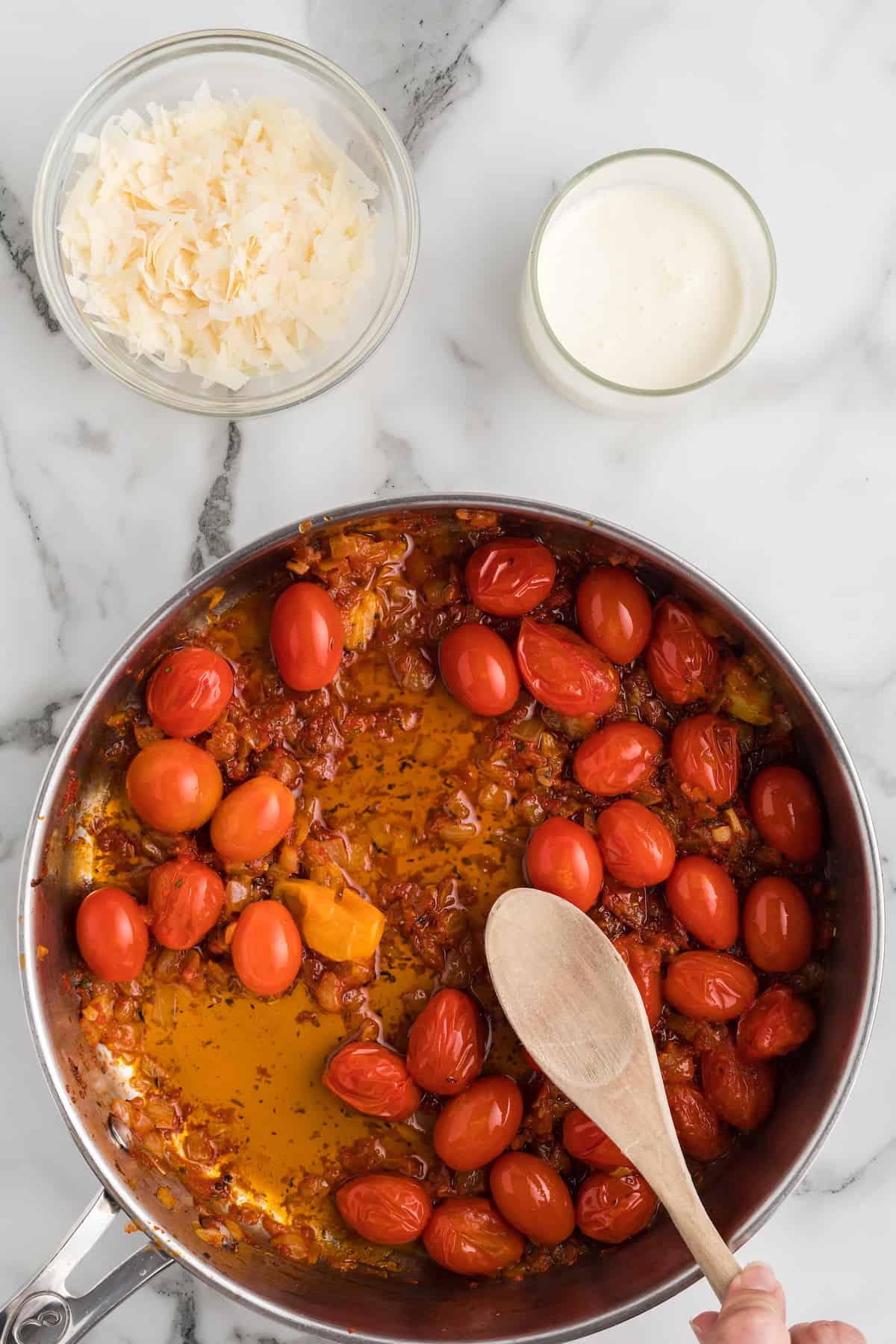 small heirloom cherry tomatoes added to the skillet with the tomato paste mixture.