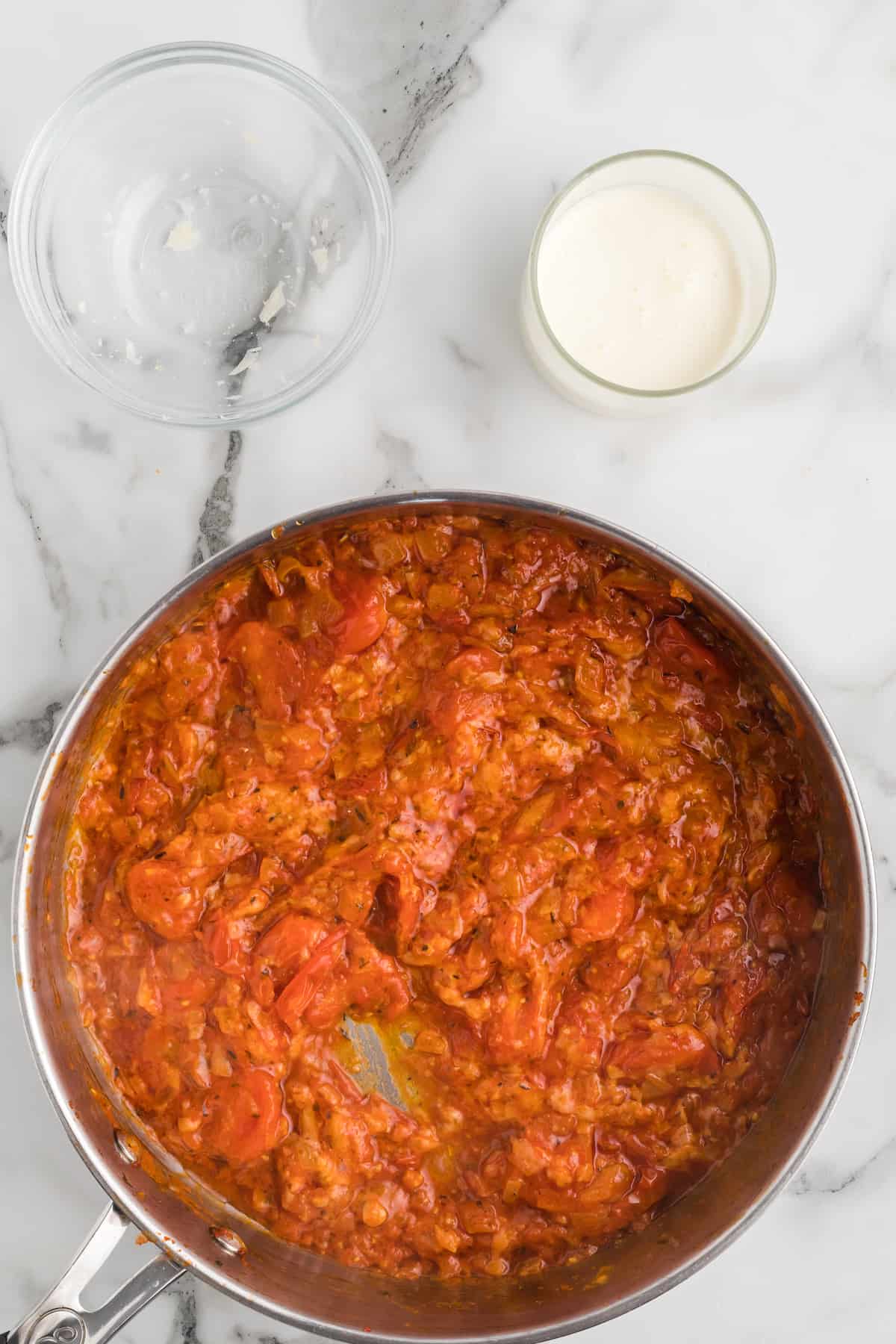 tomato paste combined with the onions, garlic, and parmesan cheese in a skillet.