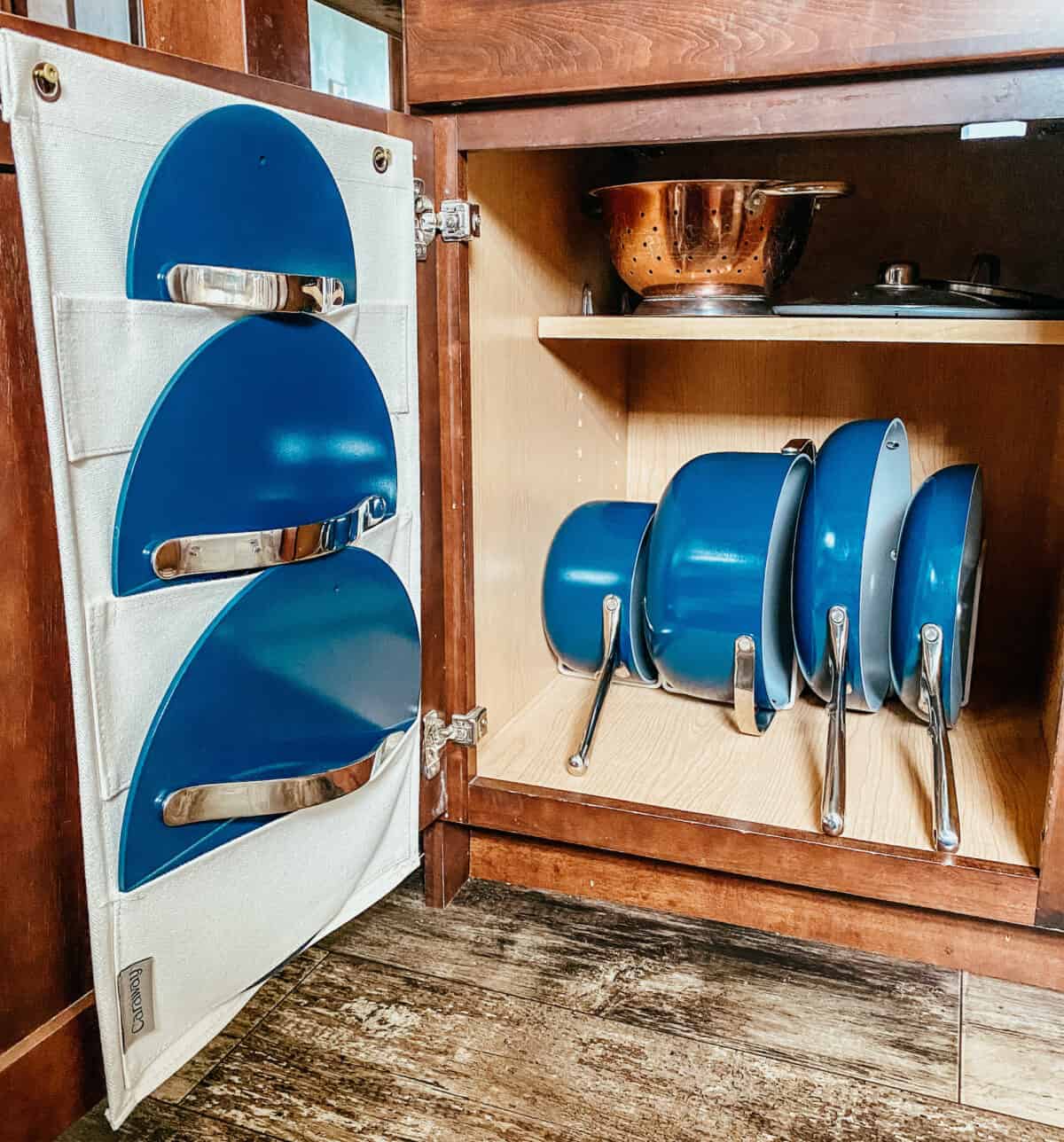 caraway cookware with storage pieces in a cabinet.