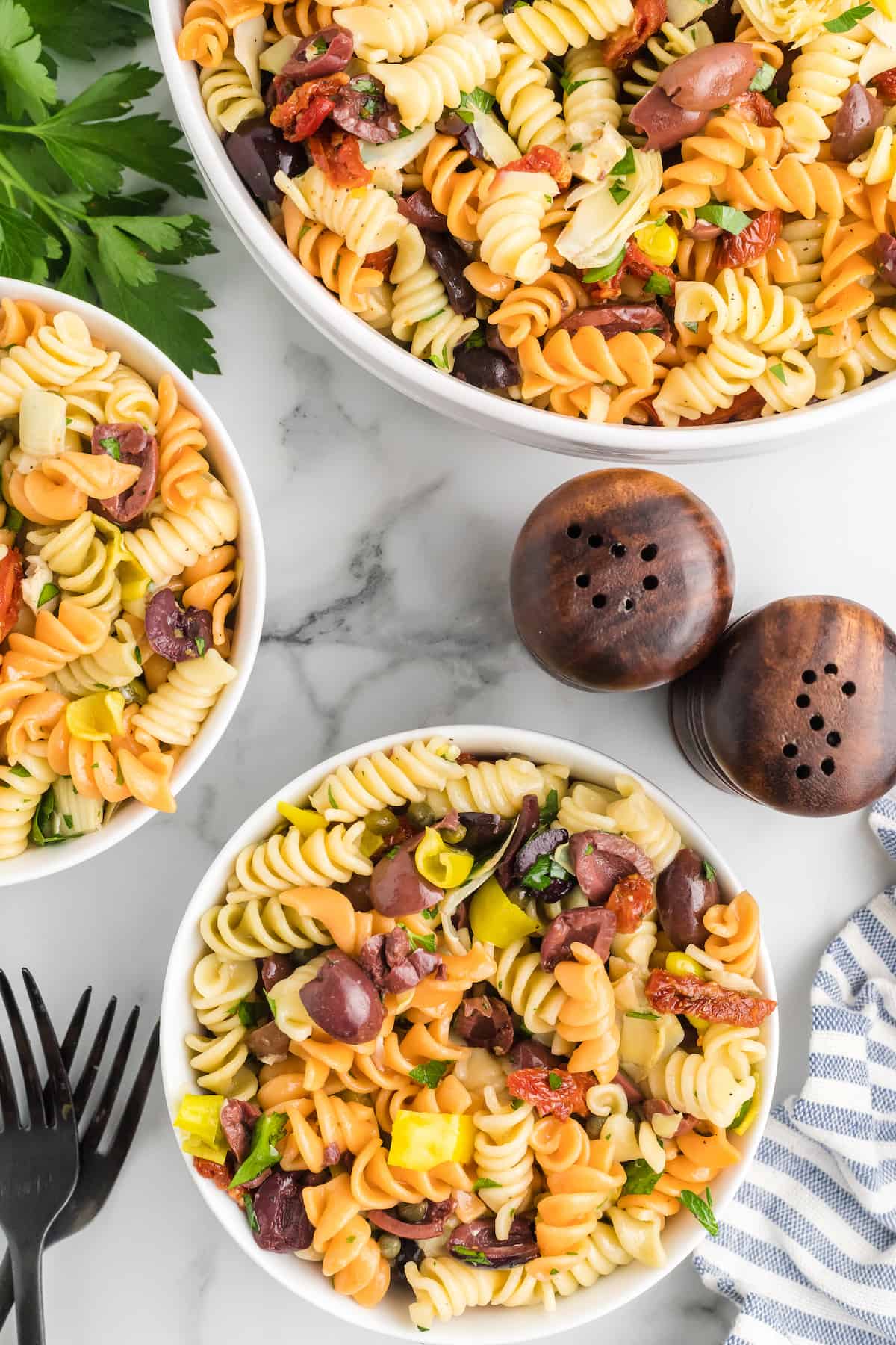 Mediterranean pasta salad in two white bowls.