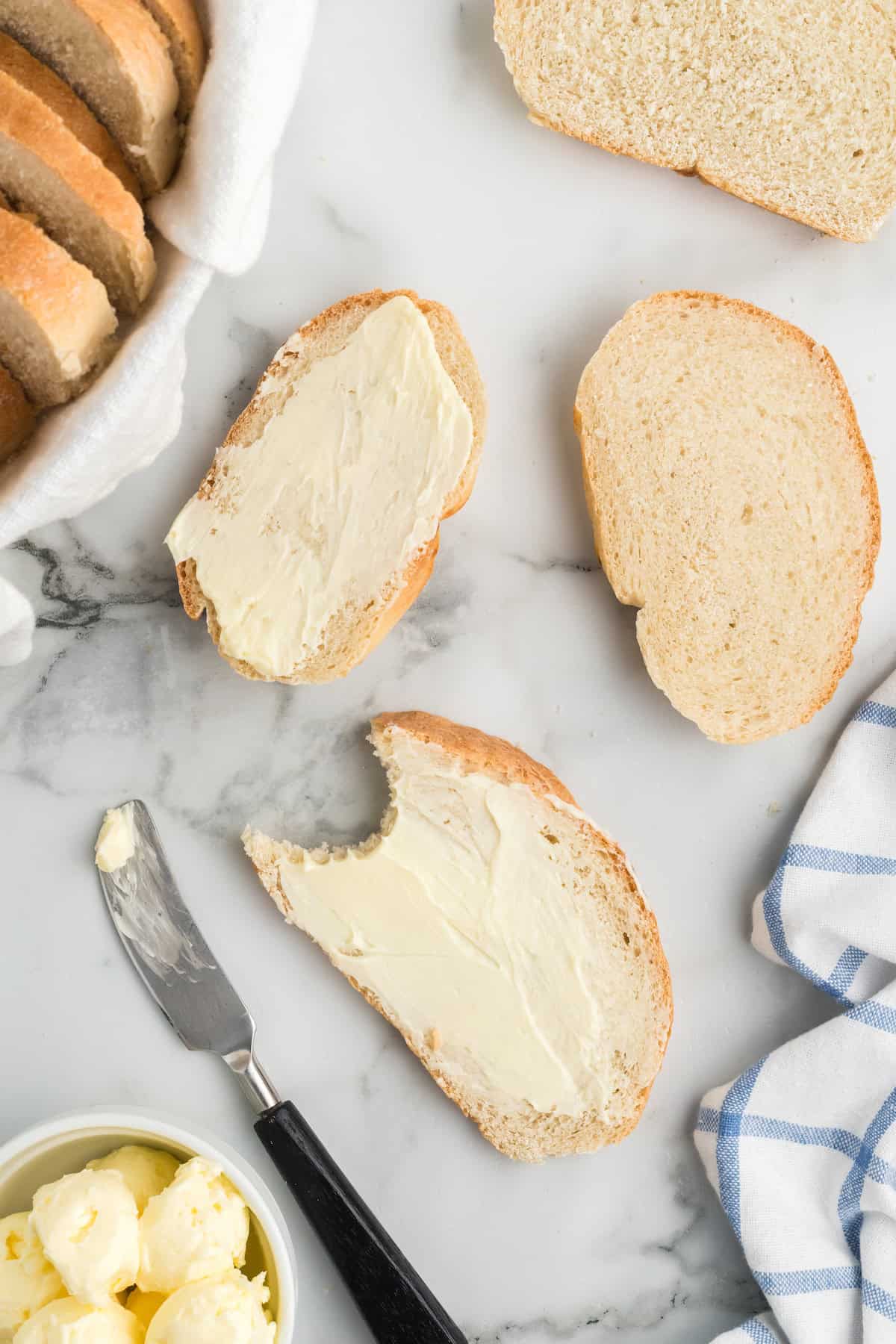 slices of the rustic italian bread loaf spread with softened butter.