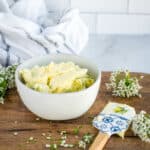 chive blossom butter in a small white bowl.