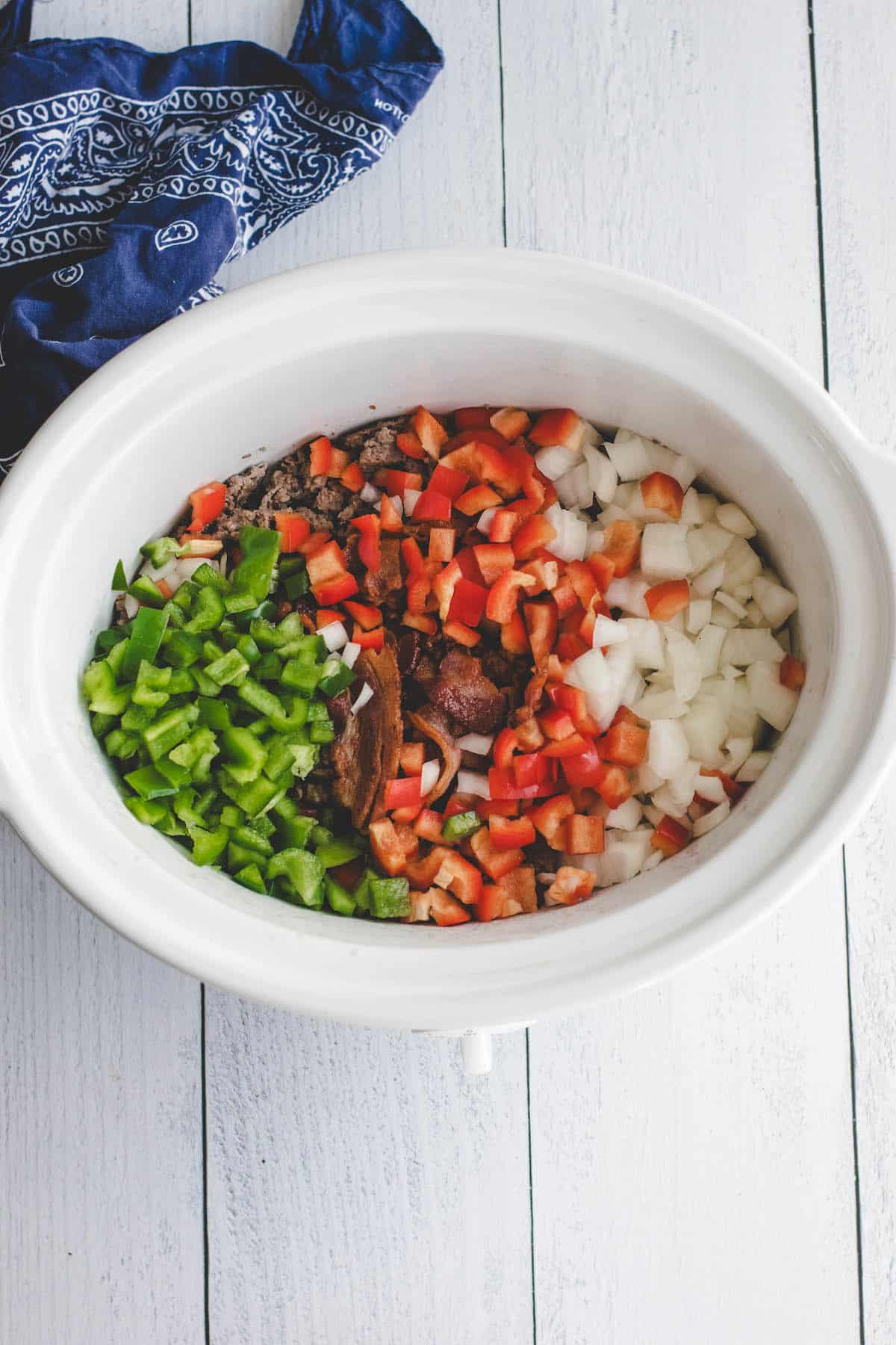 diced onions, red & green bell peppers in a slow cooker. 