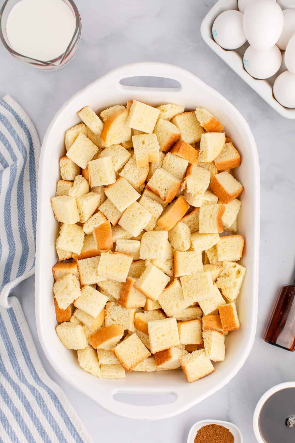 cubes of bread cut up in a casserole dish. 