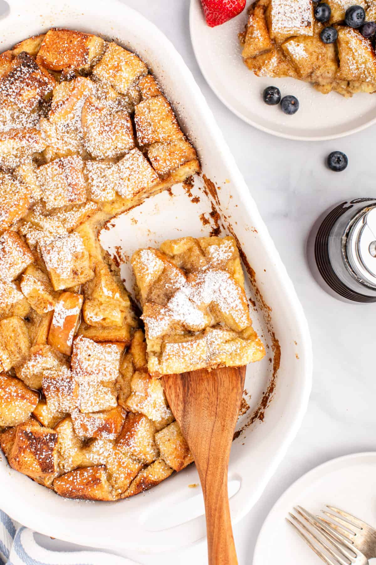 white casserole dish with slices of baked French toast.