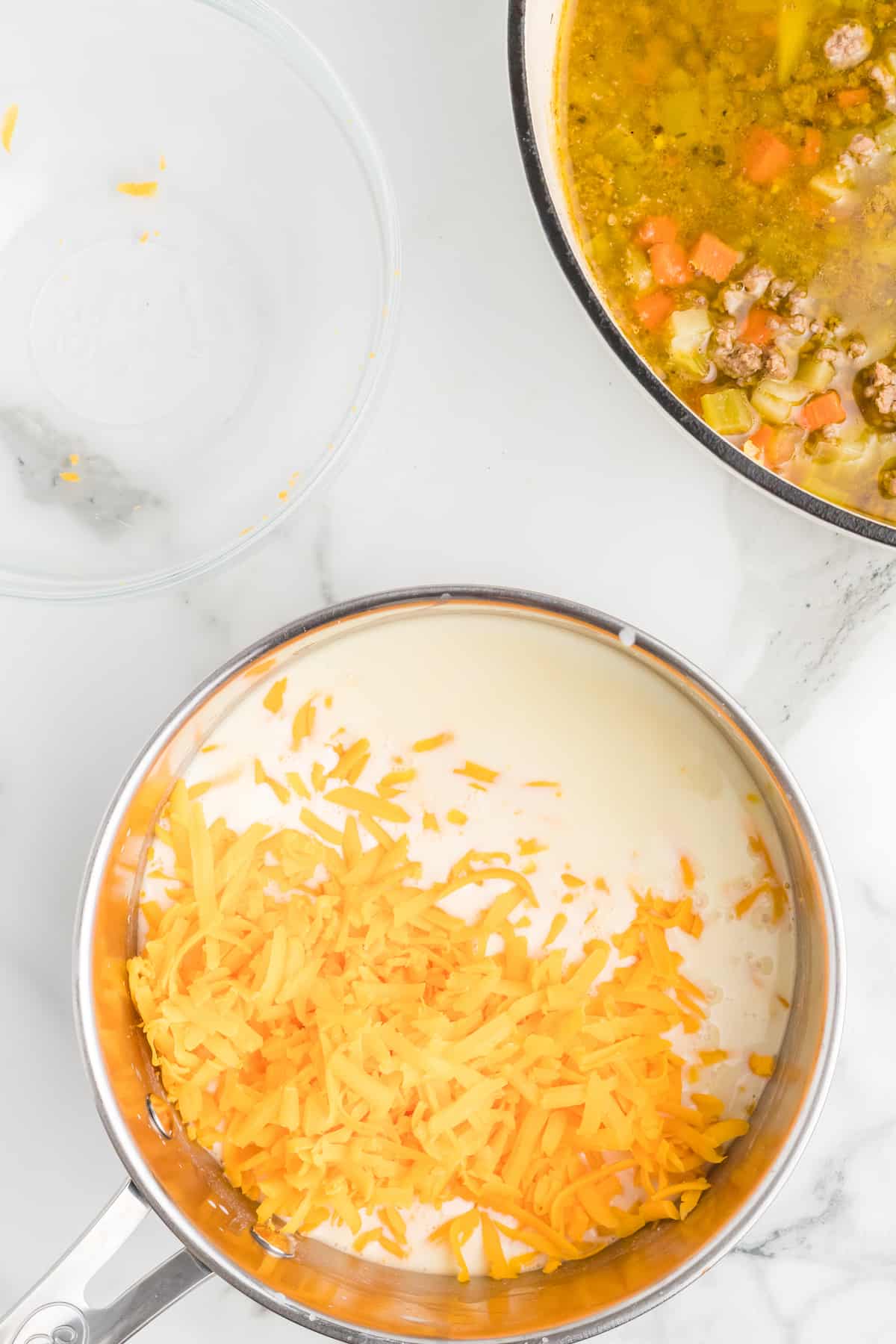 milk and shredded cheese to make the cheese sauce for the healthy cheeseburger soup recipe. 