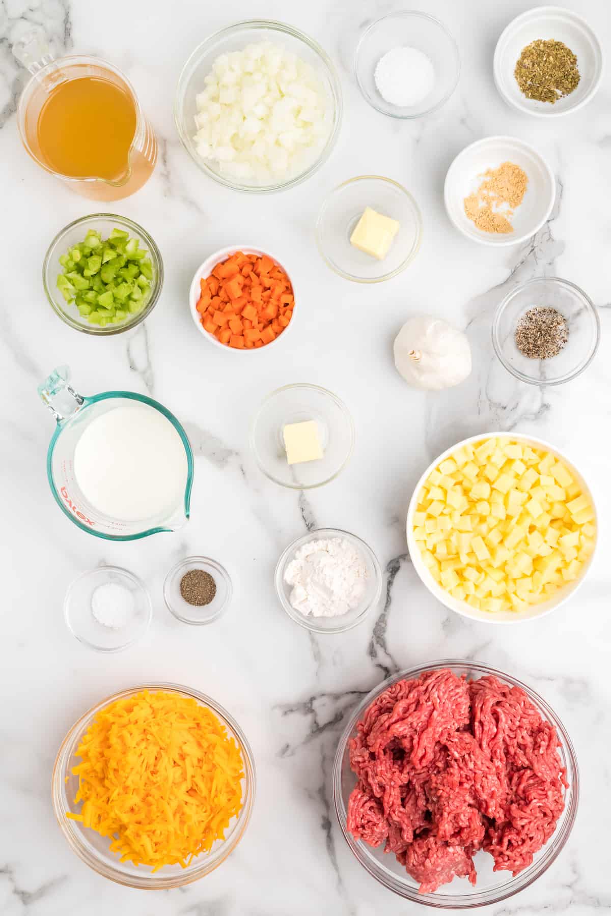 ingredients needed for healthy cheeseburger soup in small bowls.