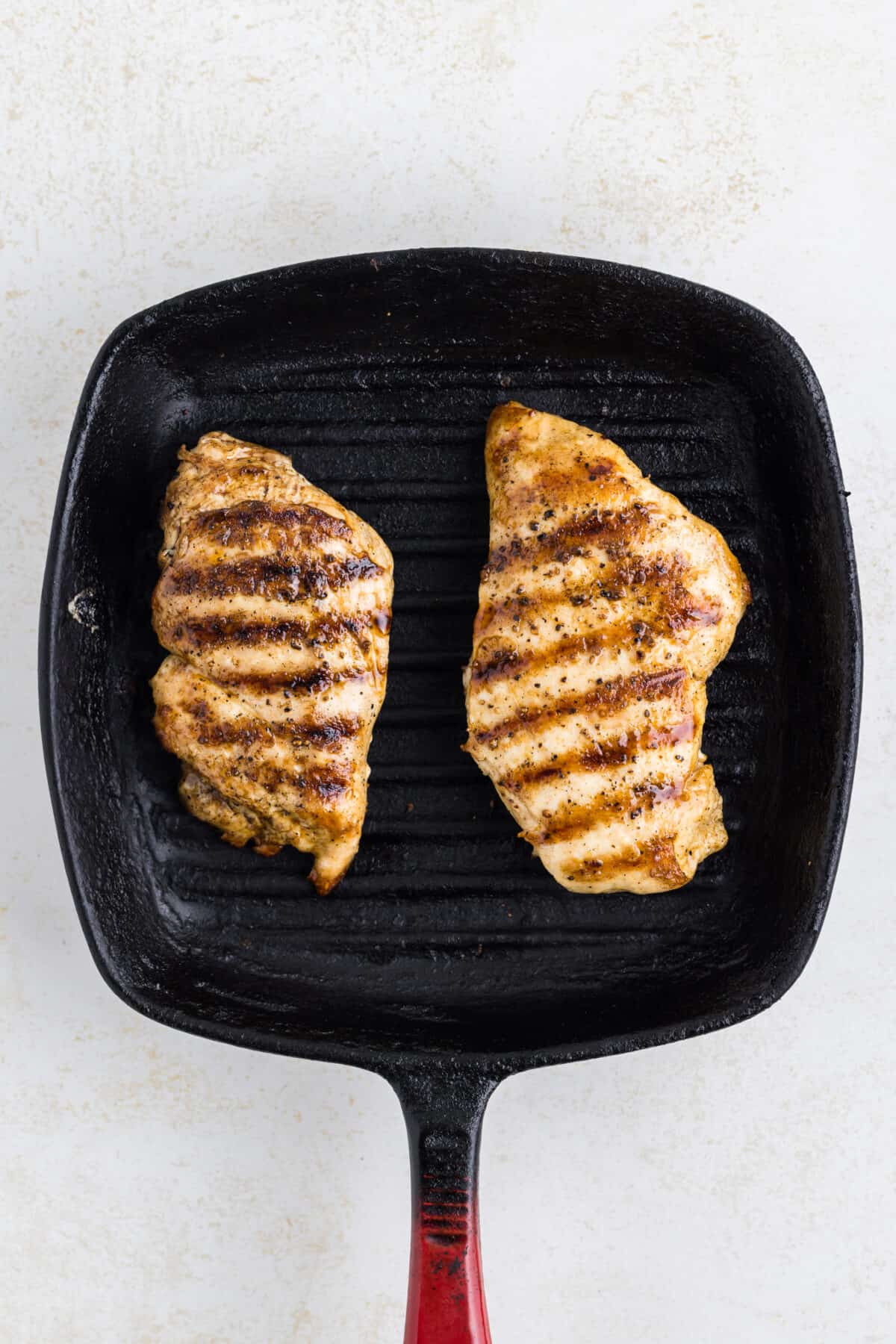 cooking the chicken breast on the grill pan.