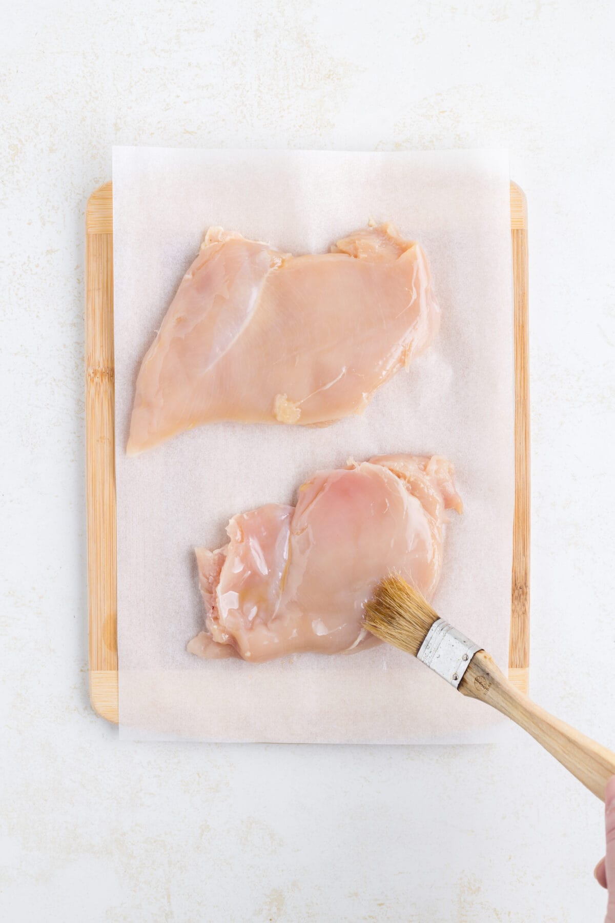brushing the chicken breasts with olive oil.