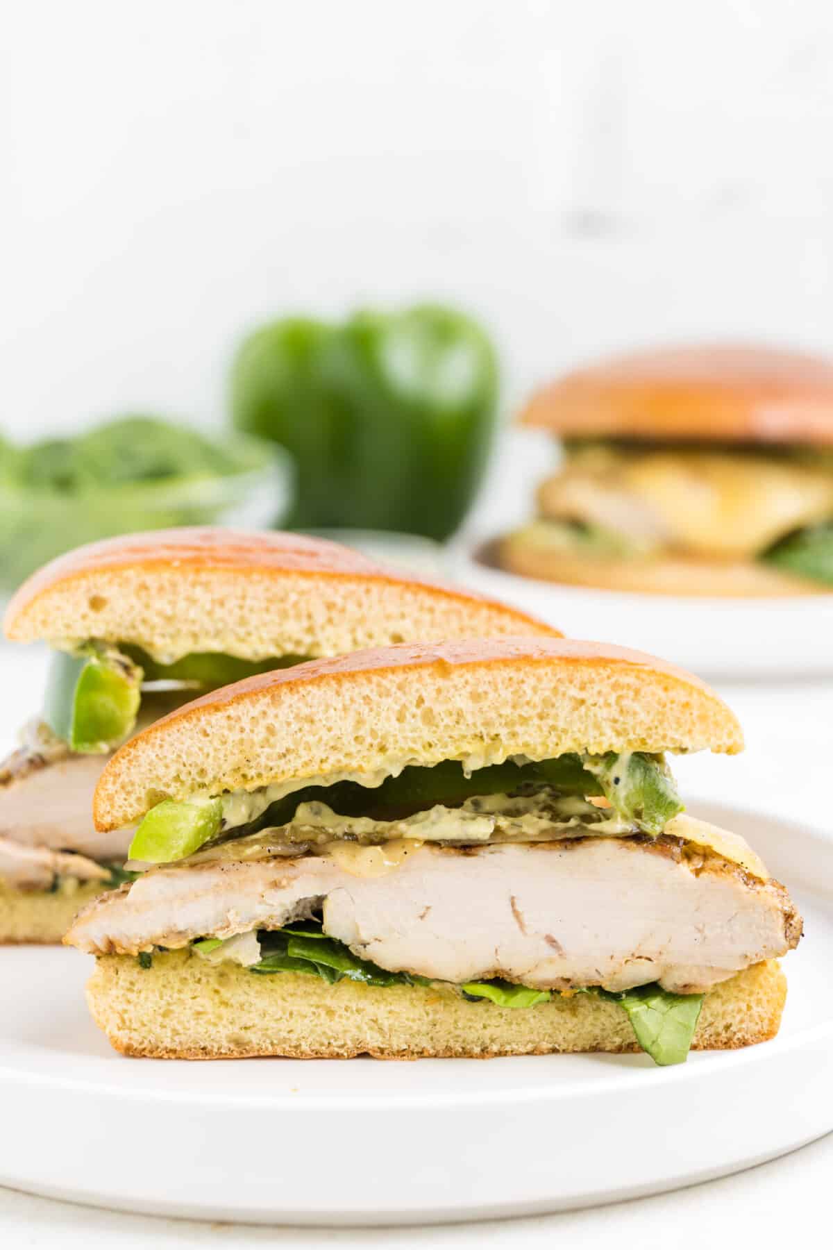 grilled chicken sandwich on a bun and cut in half to show texture. 