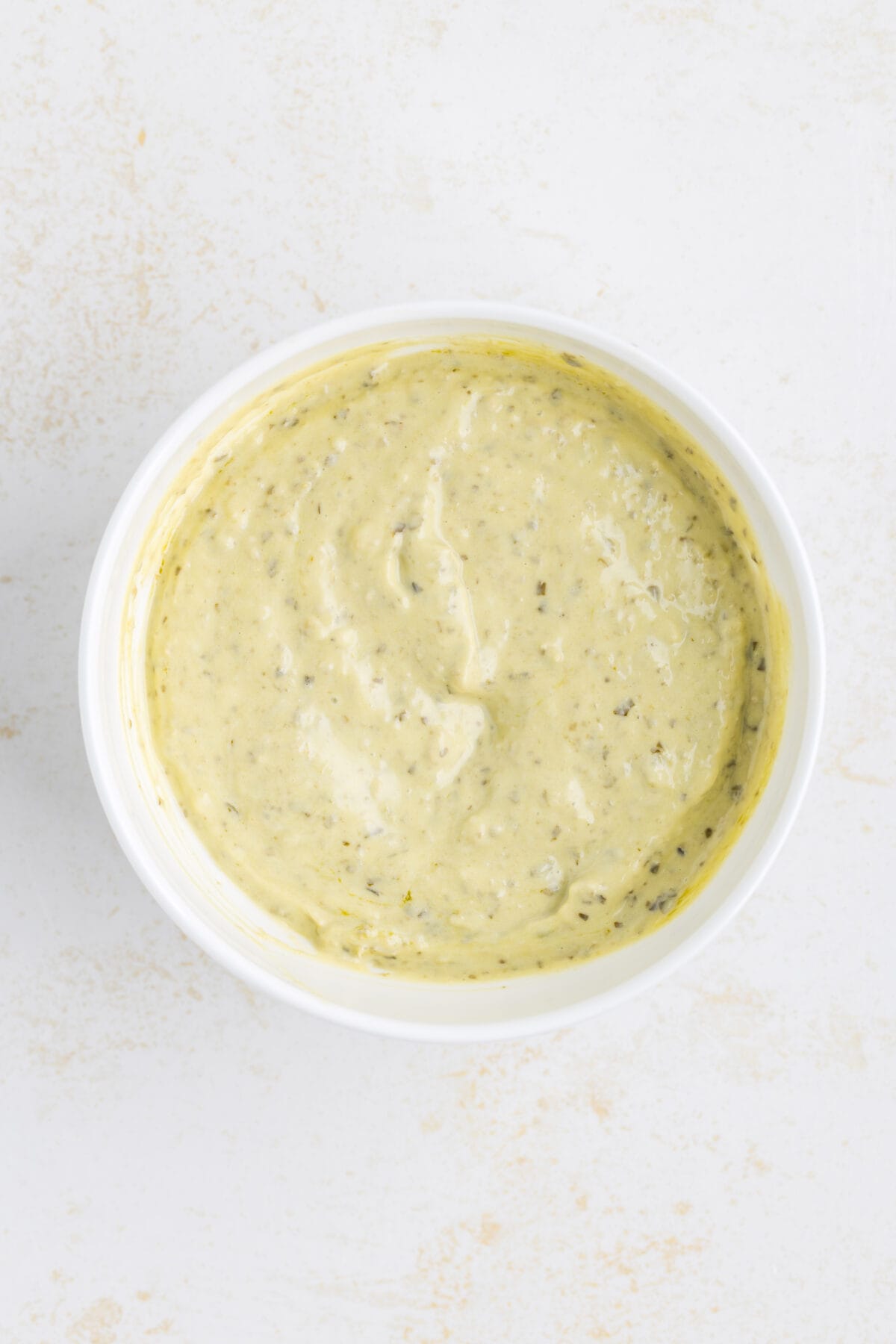 combined basil pesto mayo in a small white bowl. 