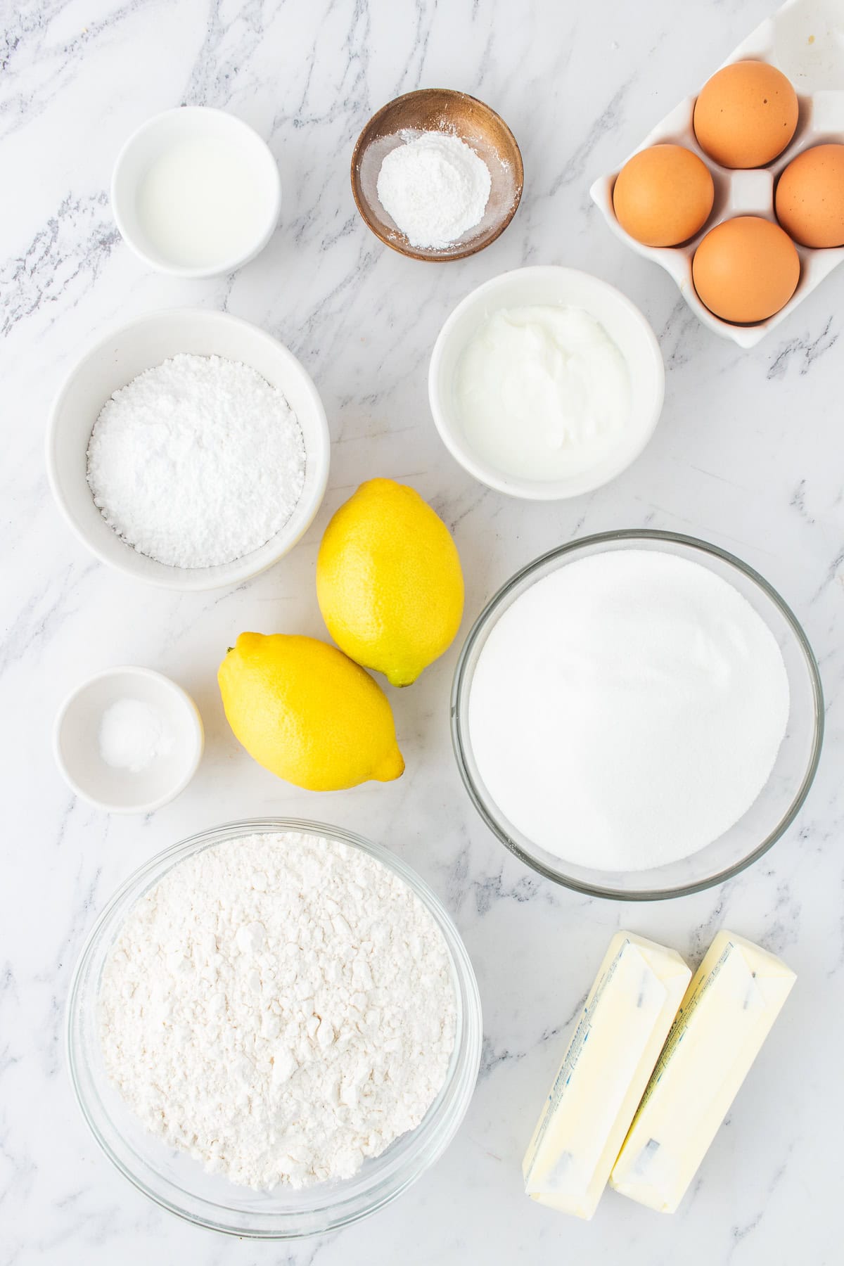 ingredients for the lemon bundt cake in small bowls. 