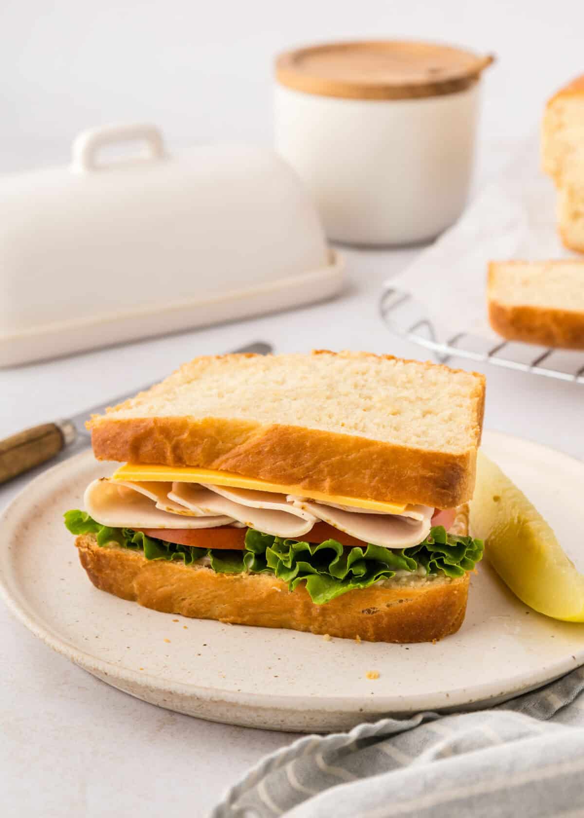 sandwich on a white plate using homemade sandwich bread.
