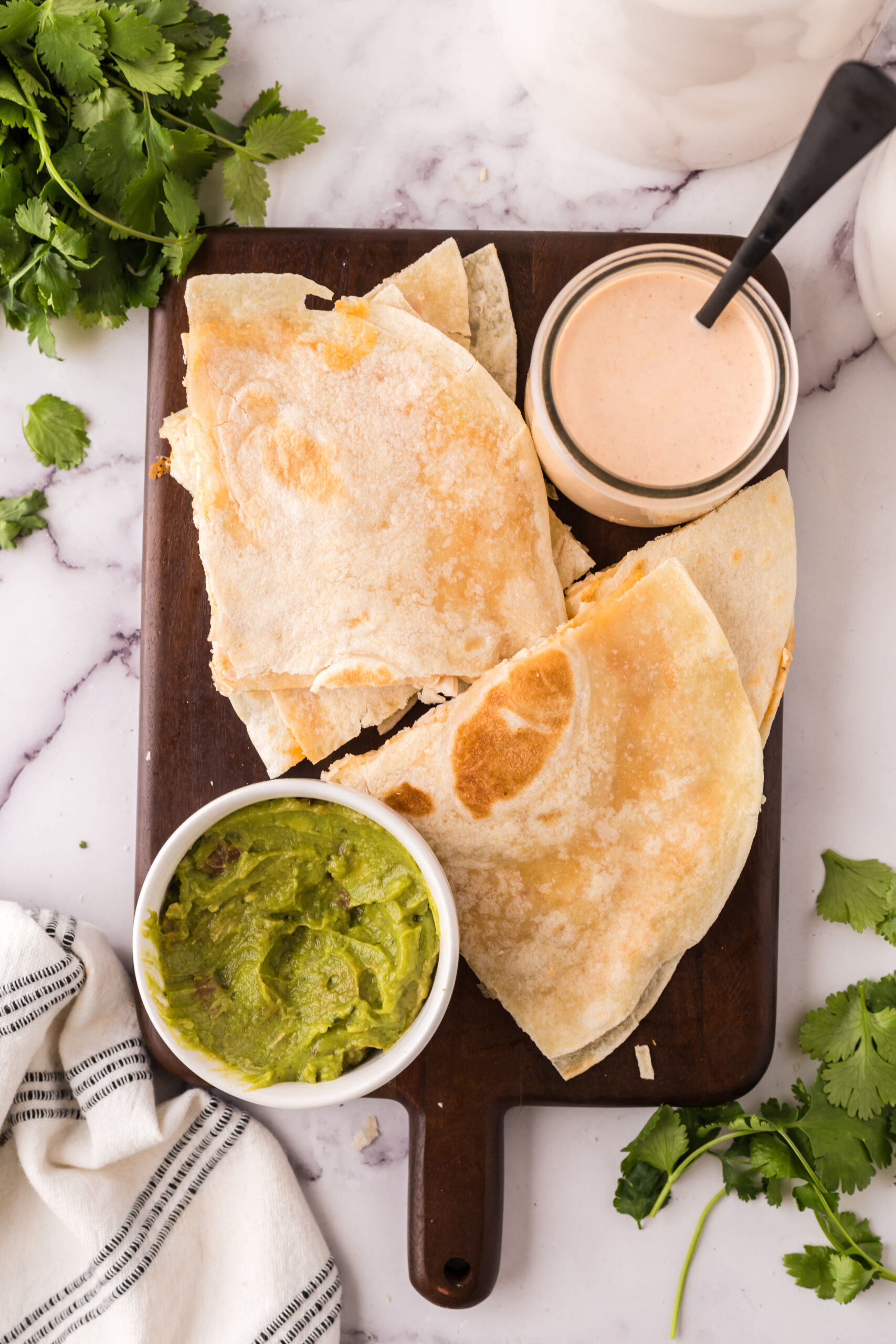 chicken chipotle quesadillas on a wooden platter.
