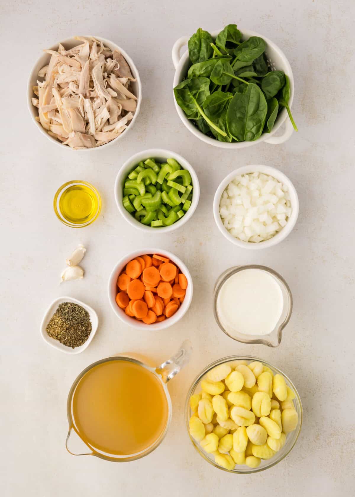 ingredients for the creamy gnocchi soup in small bowls. 