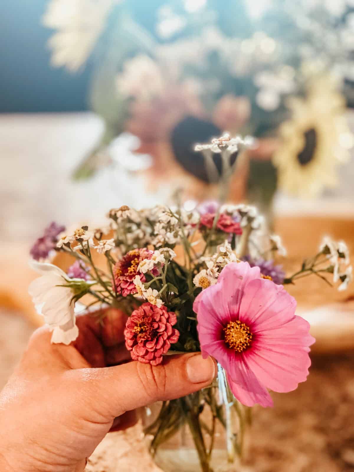 small bouquet of flowers in hand. 