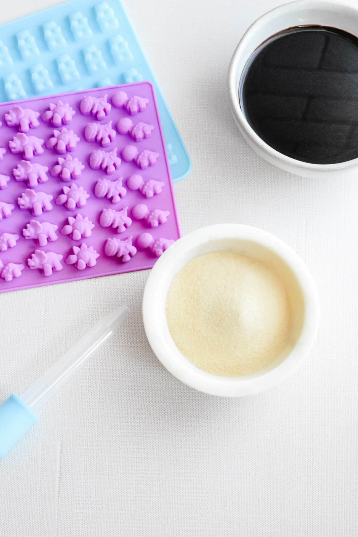 ingredients and tools needed for homemade elderberry gummies. 