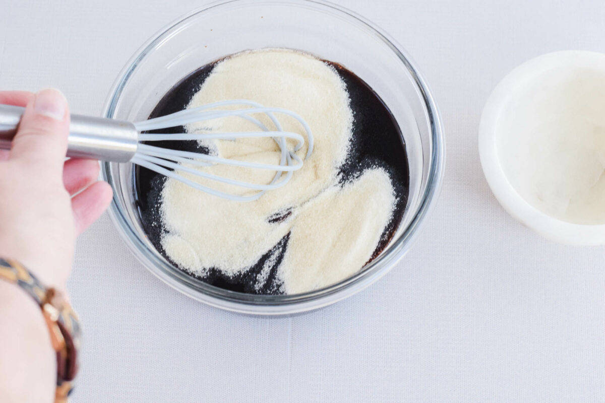 whisking the gelatin and the elderberry syrup together in a bowl. 