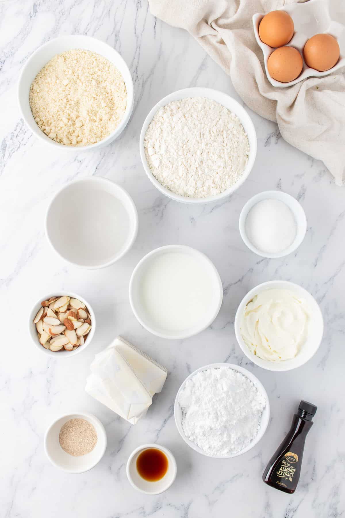 ingredients for the almond sweet rolls in small bowls. 