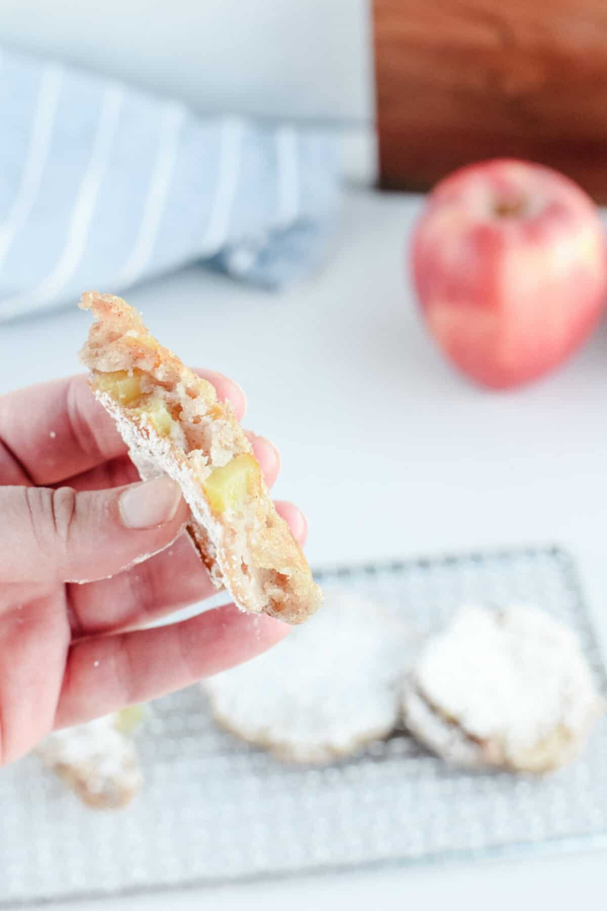 holding a sourdough apple fritter in hand.