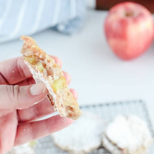 holding a sourdough apple fritter in hand.