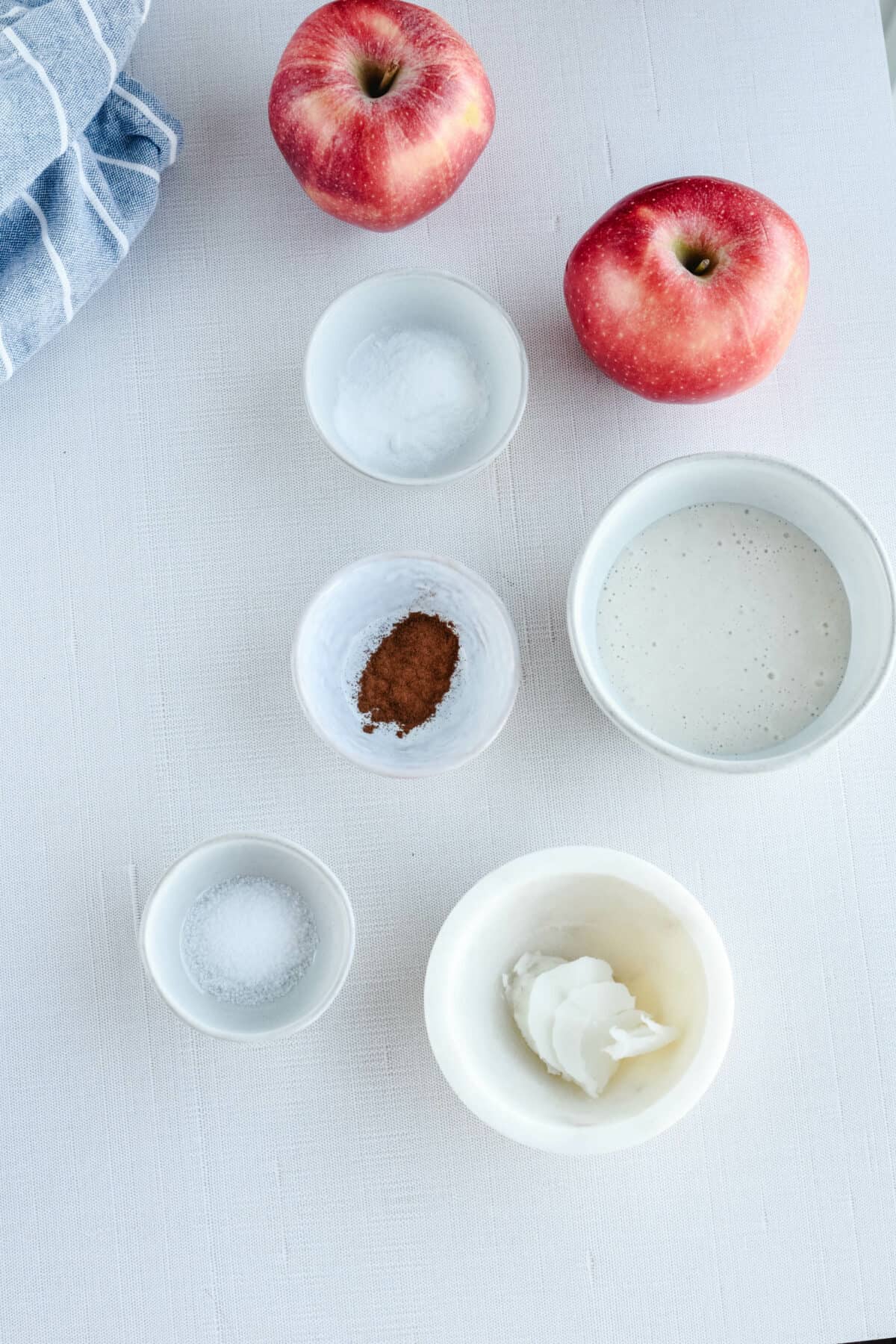 ingredients for sourdough apple fritters in small bowls.