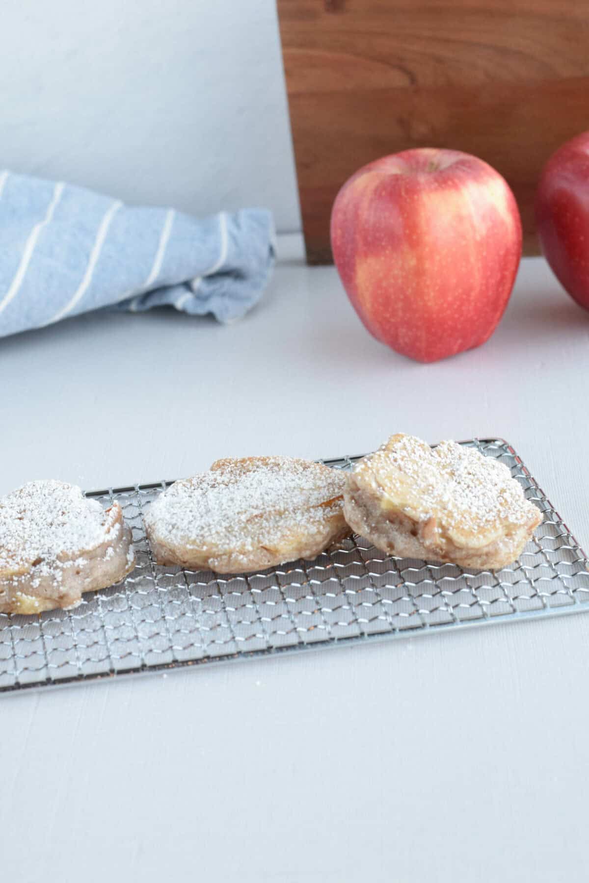 sourdough apple fritters on a cooling rack.