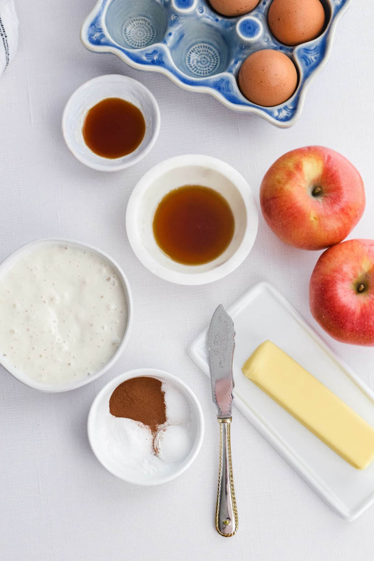 ingredients for the apple cinnamon sourdough pancakes in small bowls. 