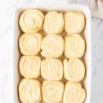 sweet rolls in a white baking dish.