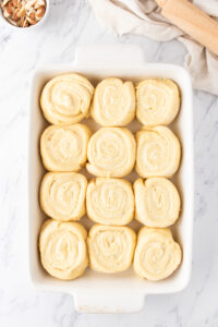 sweet rolls in a white baking dish.