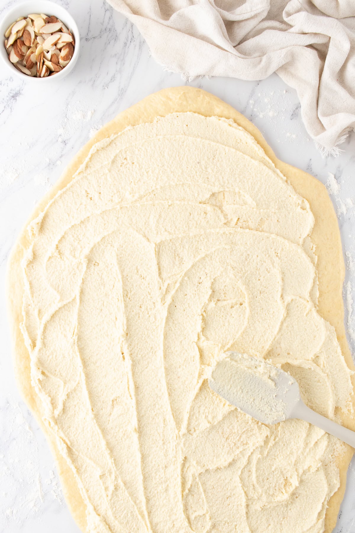 spreading the almond filling mixture to sweet dough. 