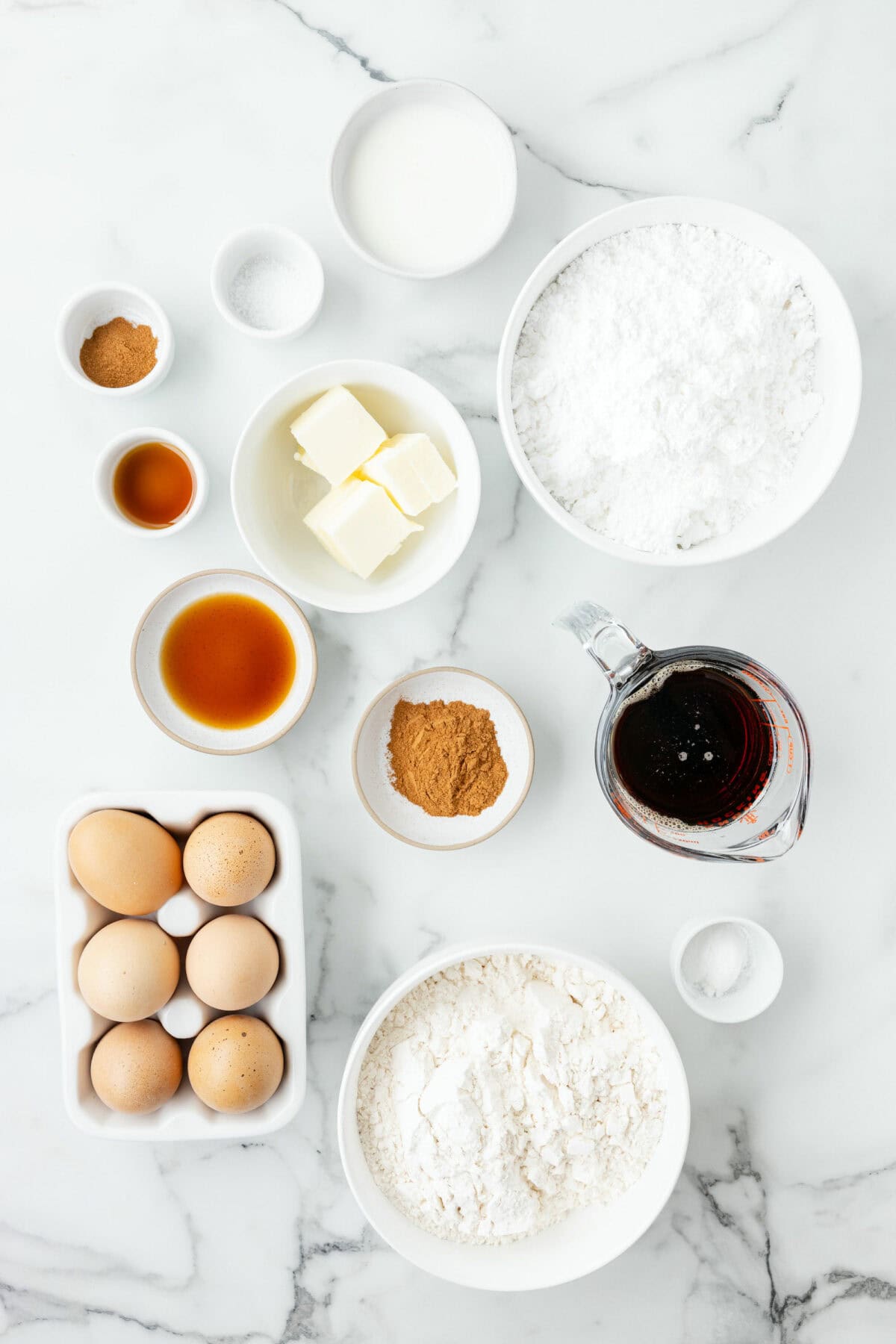 ingredients for the pumpkin spice biscotti recipe in small bowls. 