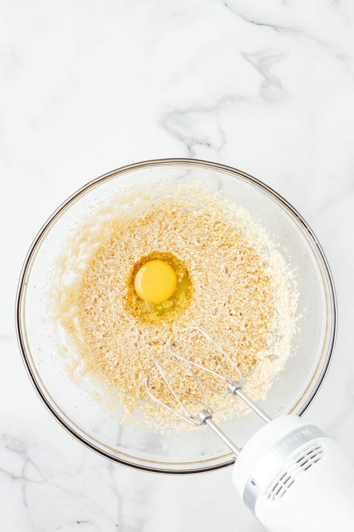 adding the egg to the mixing bowl. 