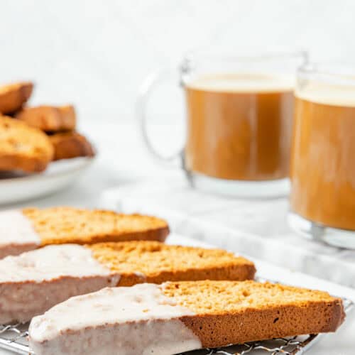 wire rack with pumpkin spice biscotti cooling with the glaze.