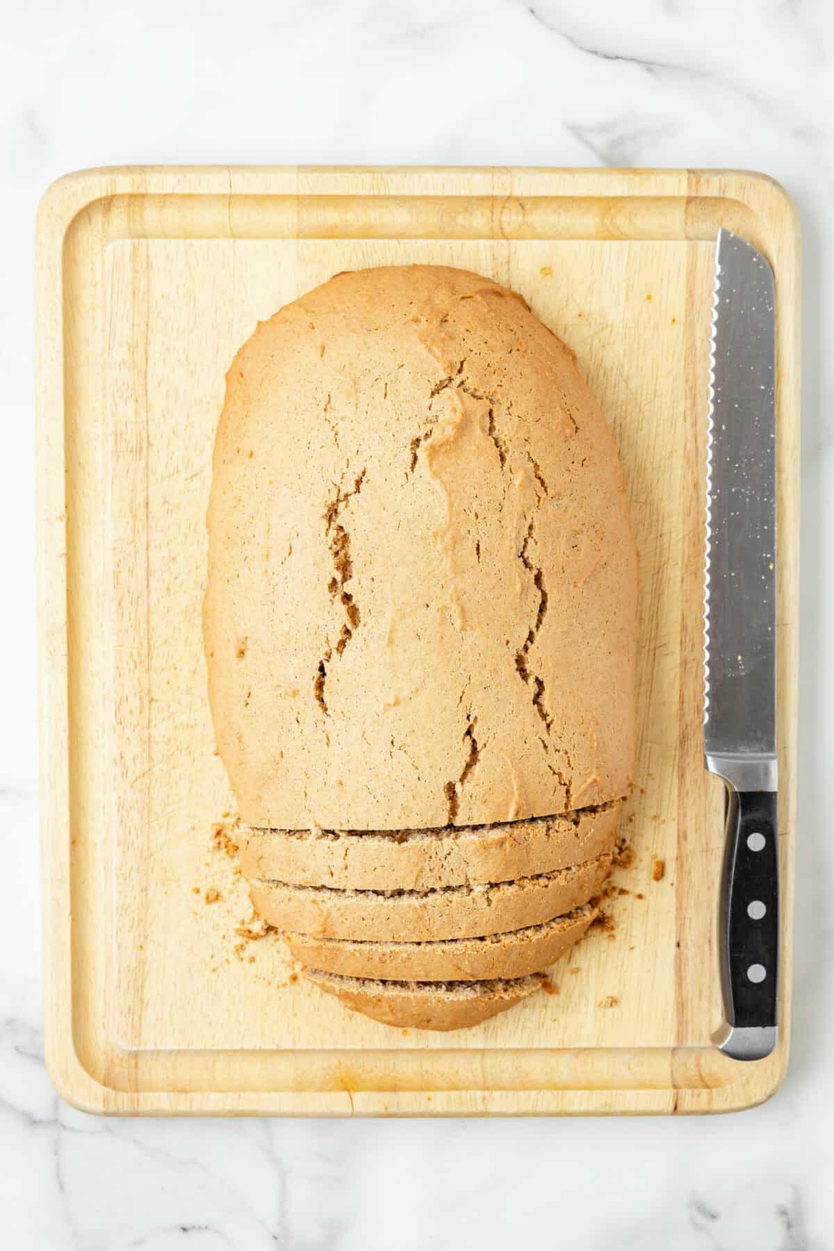 Slicing the biscotti on the baking sheet. 