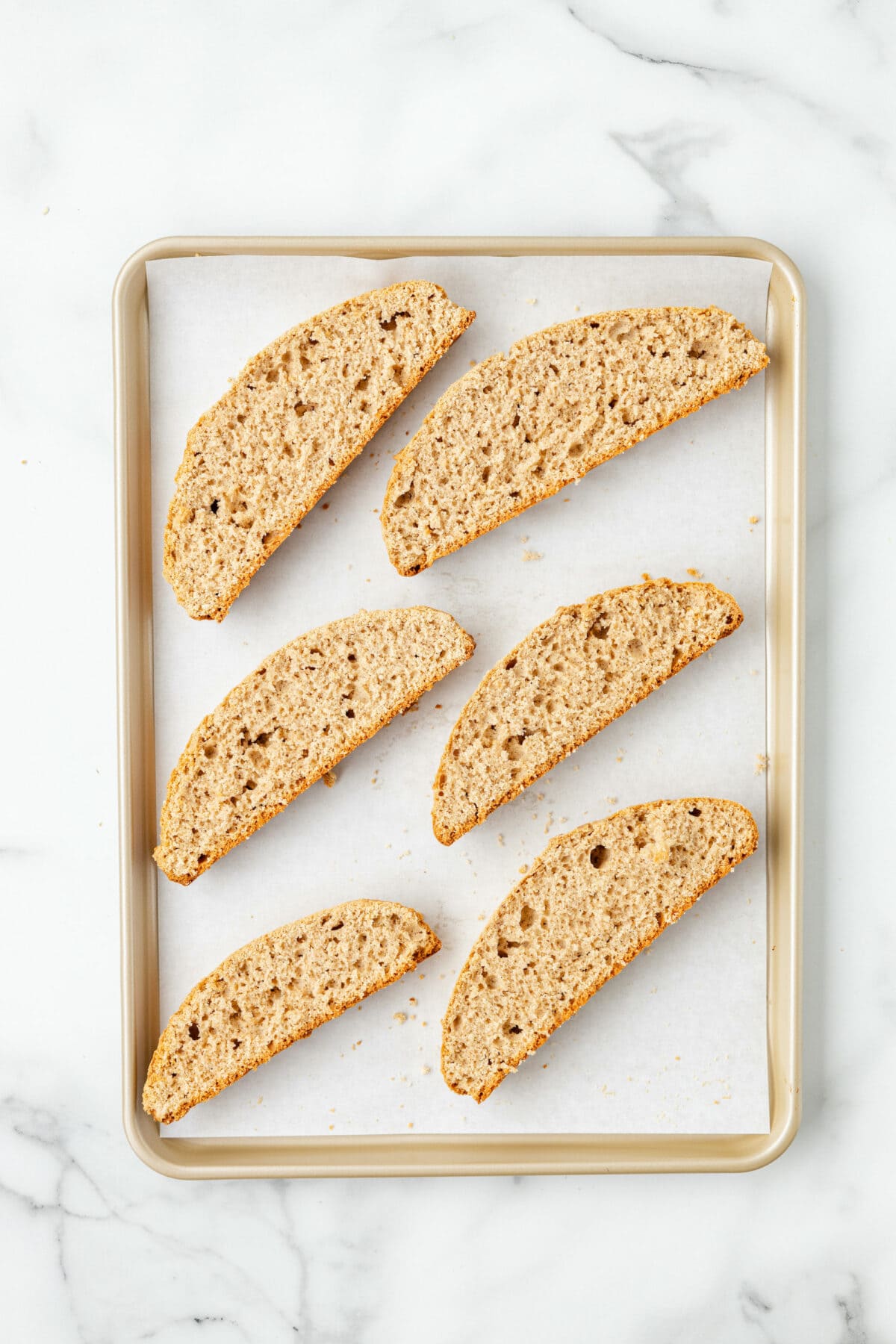 lining the baking sheet with sliced biscotti to bake again. 