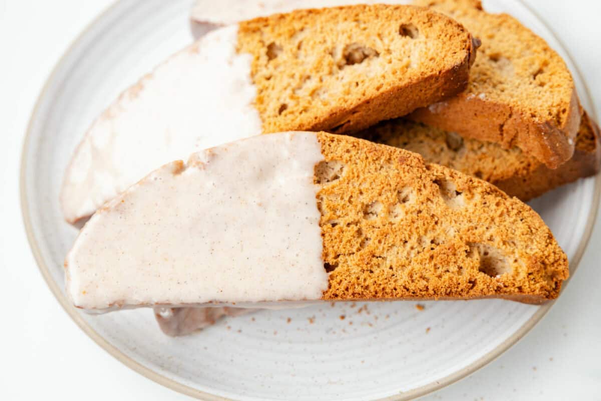 pumpkin spice biscotti stacked on a white plate. 