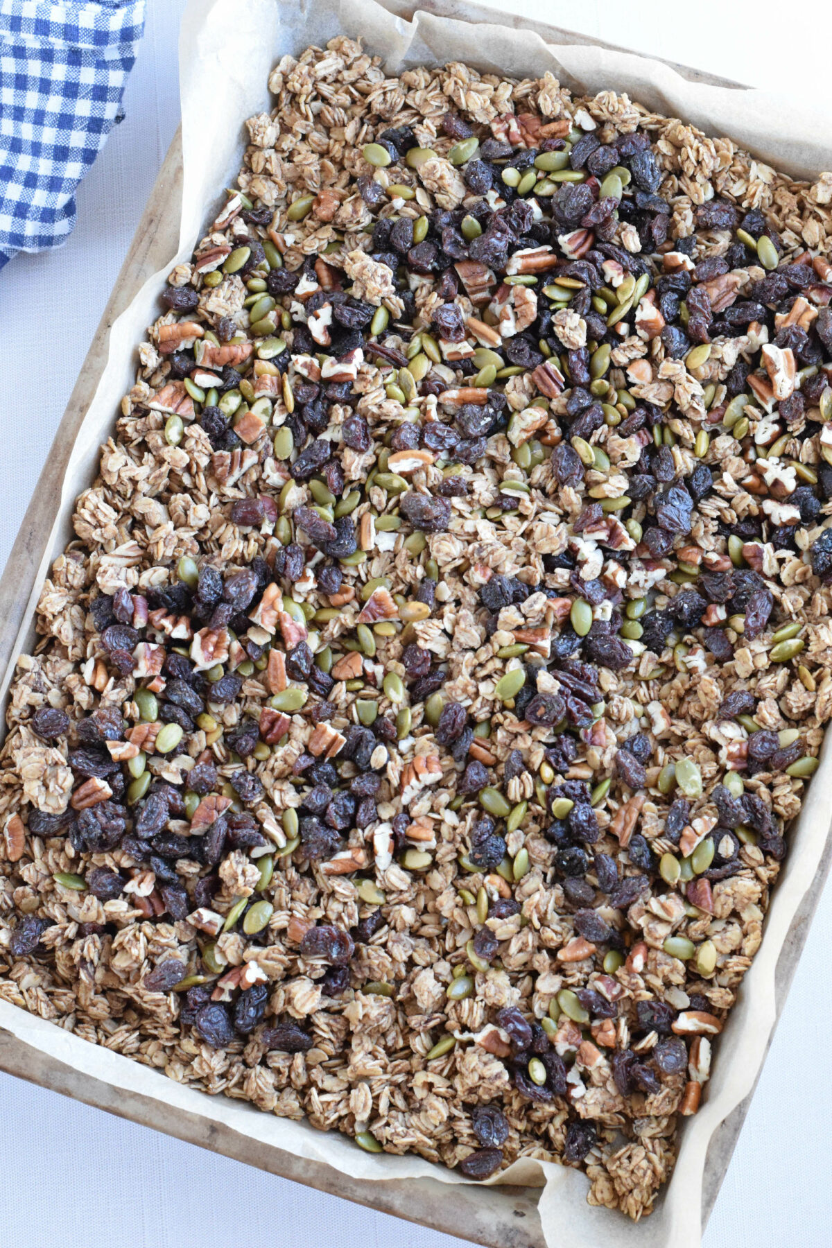 finished sourdough granola on a sheet pan with the raisins and nuts. 