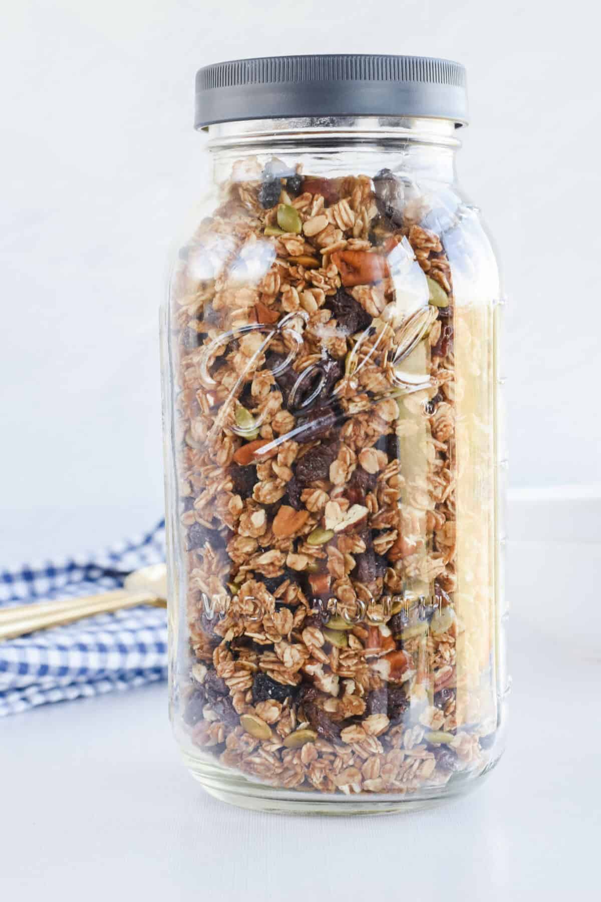 mason jar of pumpkin spice sourdough granola on a table top.