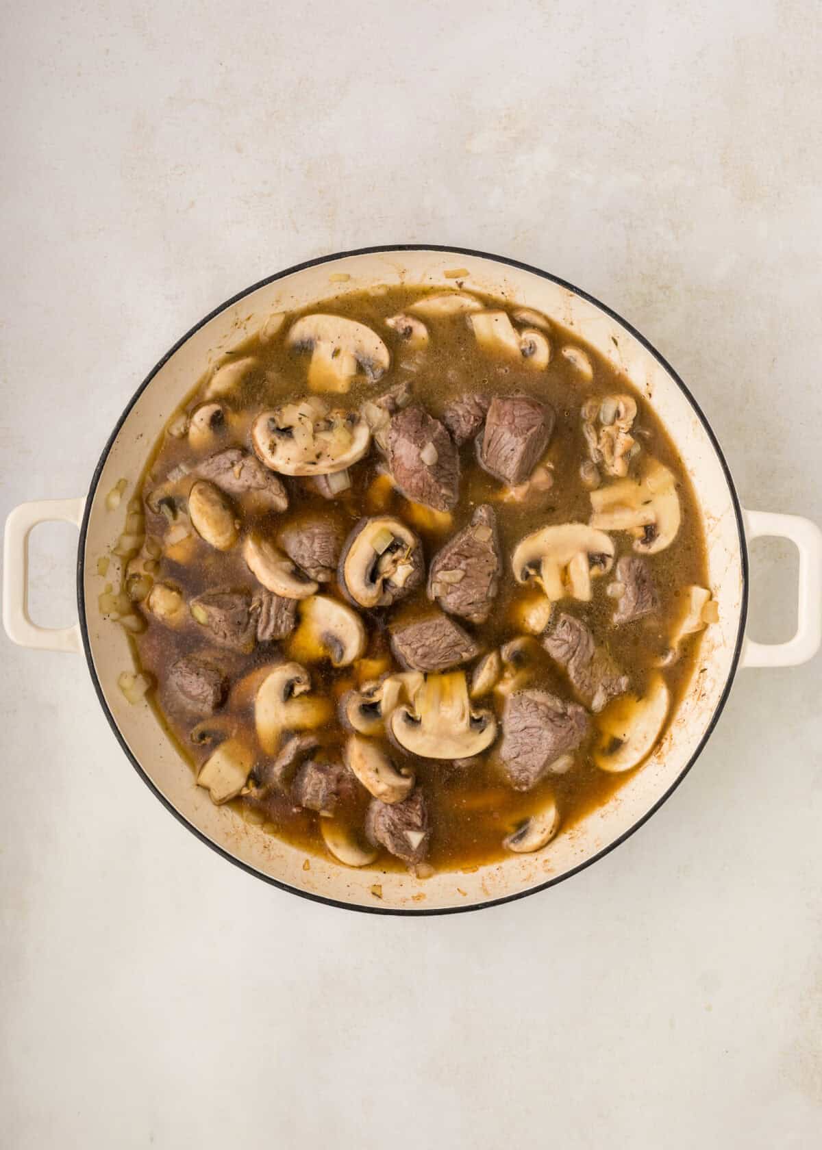 beef broth added to the dutch oven with the beef and mushrooms. 