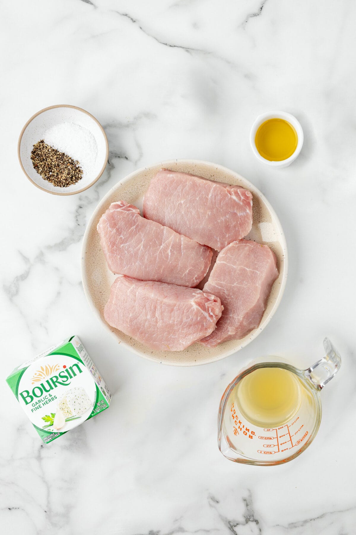 ingredients for the creamy pork chops on plates and small bowls. 