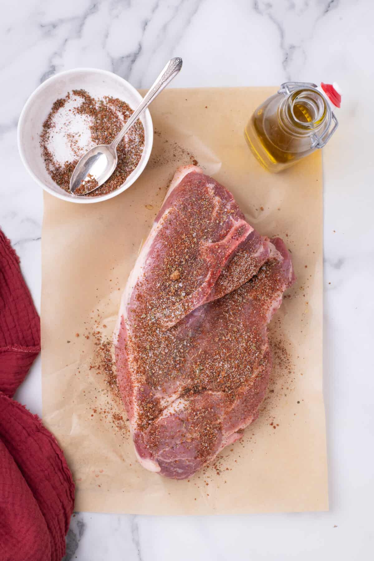 pork shoulder with olive and seasoning rub over top. 