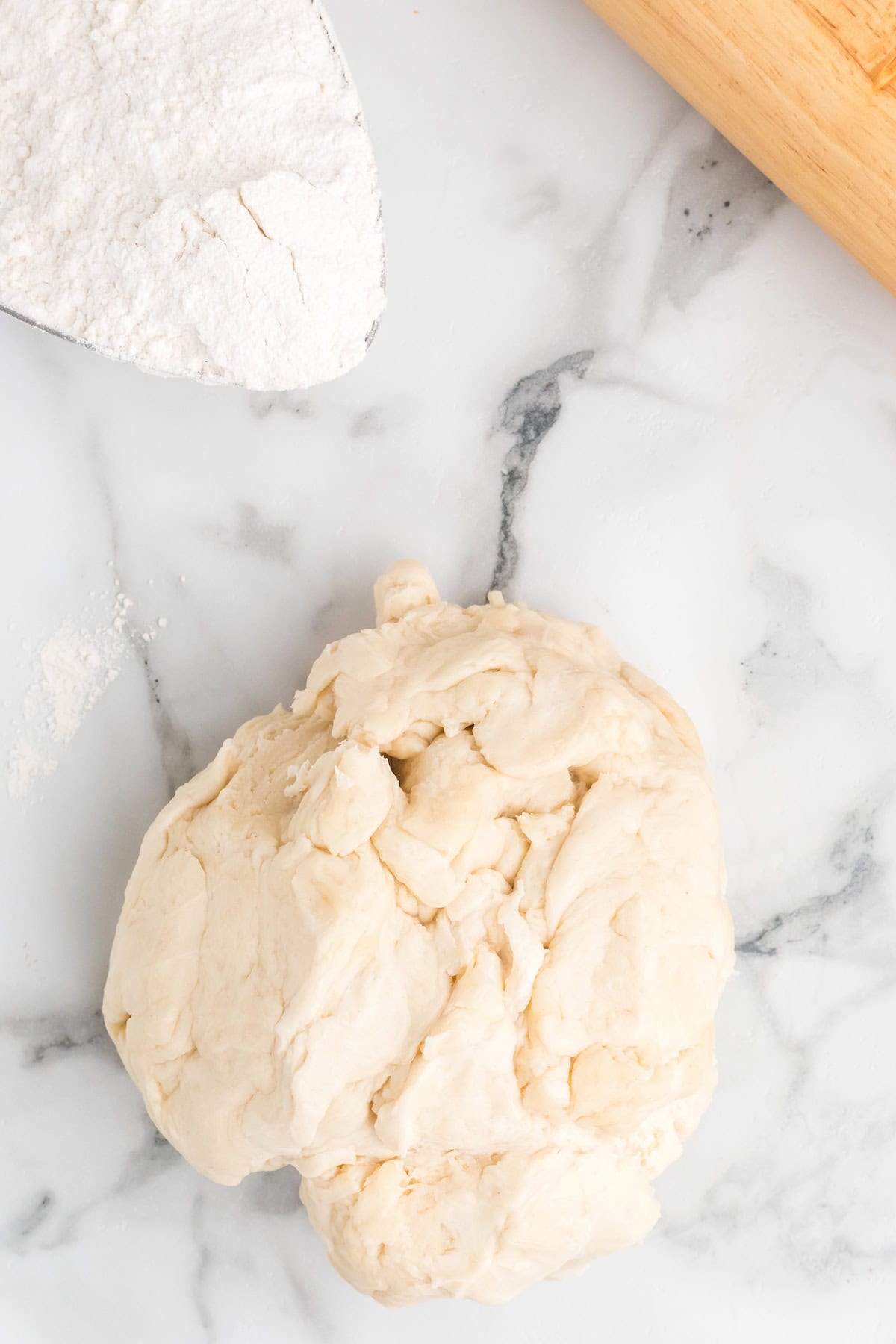 pie crust dough ball on countertop. 