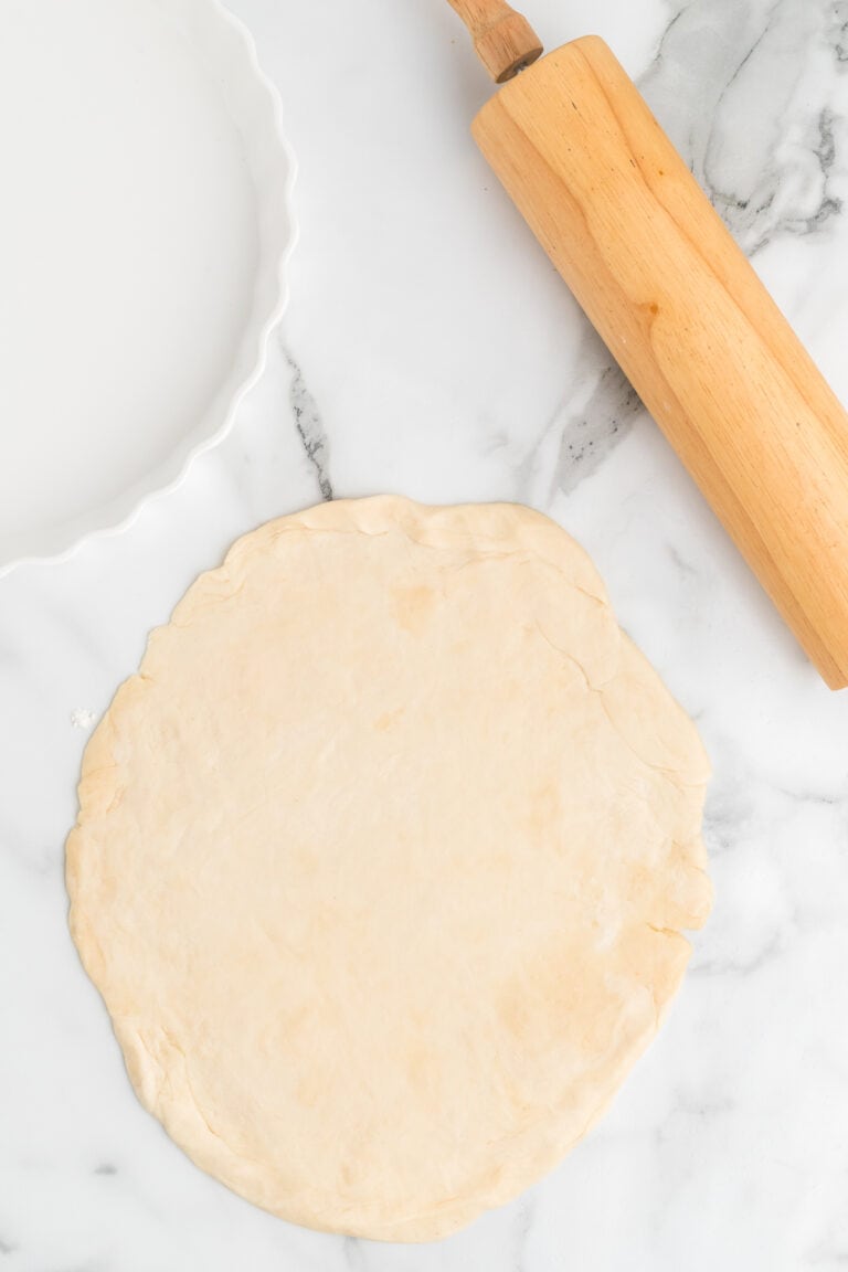 all butter pie crust rolled out on the counter.